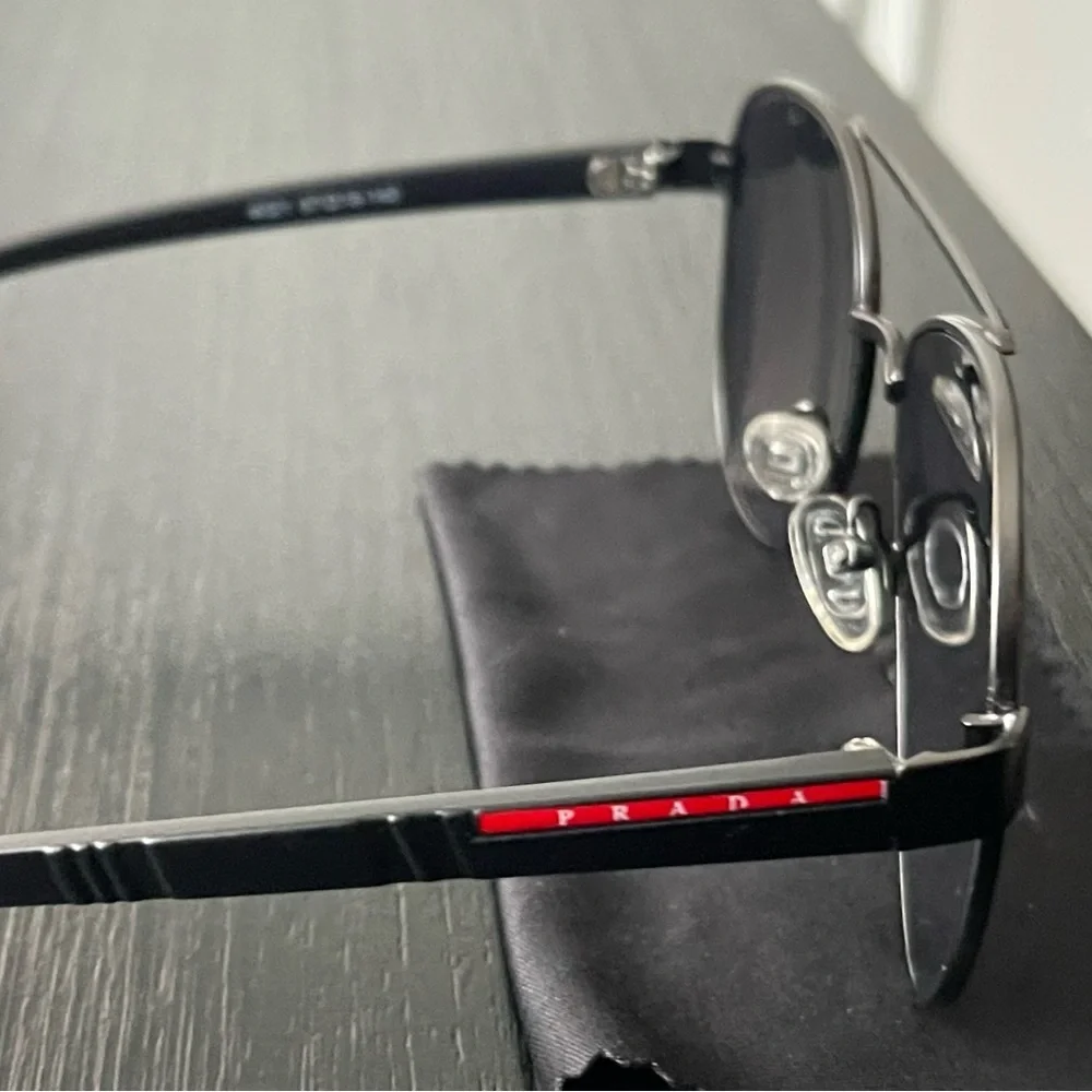 Prada Silver Aviator Sunglasses with Dark Blue and Purple Lenses